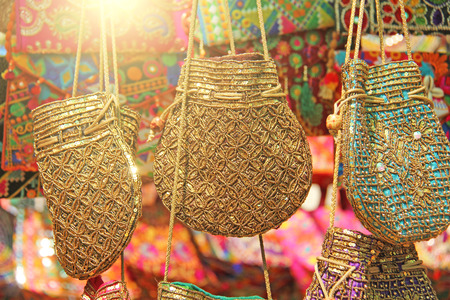 Bright national Indian colored bags are sold in the market of bazaars in India, Goa. Souvenirs Gifts India. Hand embroidery in gold.の写真素材