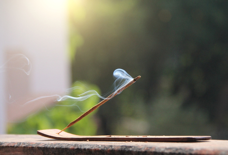 Incense stick and smoke from incense burning. Beautiful smoke. Blurred background and design with copy space.の写真素材