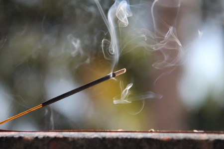 Incense stick and smoke from incense burning. Beautiful smoke. Blurred background and design with copy space.の写真素材