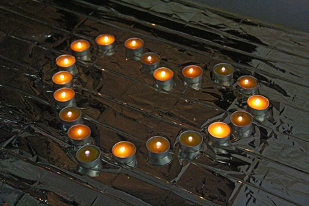 Heart of lights or candles. Candles are lined in the form of a heart.の写真素材