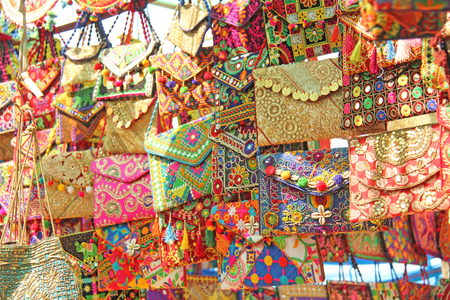 Bright national Indian colored bags are sold in the market of bazaars in India, Goa. Souvenirs Gifts India. Hand embroidery.の写真素材