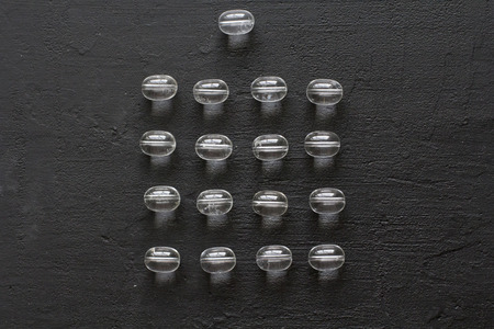 Stone rhinestone, rock crystal. Natural transparent stones lie on a black modern background. Spa,...