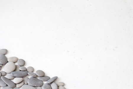 Spa background with grey stones, gray modern background, cover, template with round gray stones, flat lay. Copy space for your text. Stones scattered on a gray background.の写真素材