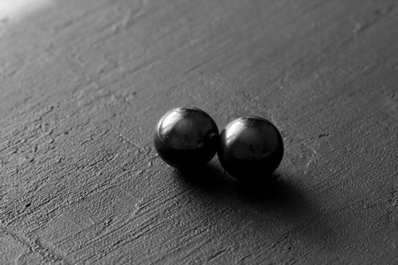 Stone magnetite, attraction, black hole. Natural balls of magnetite are attracted to each other, on...