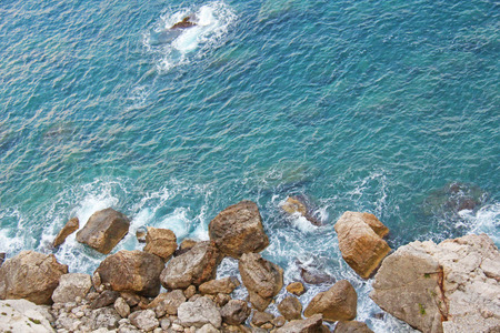 View from Above on the Sea and Stones or Rocks in the City of Taormina. The island of Sicily, Italy. Beautiful and Scenic View of the Sea and Rocks.の写真素材