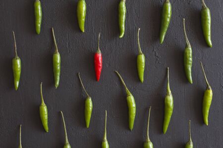 Green Hot Chili Peppers On Black Dark Background on Black Table. A Lot of Chilli Peppers. Copy space...