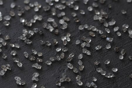 Scattered diamonds on a black background. Raw diamonds and mining, a scattering of natural diamond stones. Graphite quartz. Natural stones and minerals.の写真素材