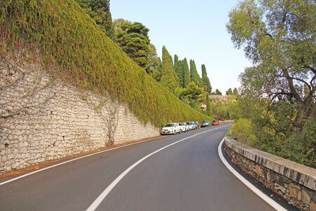 Beautiful Winding and Picturesque Green Road in the City of Taormina. The island of Sicily, Italy.の写真素材