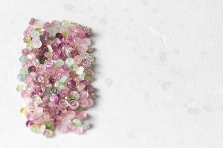 Tourmaline. Natural stone multi-colored tourmaline. Green, yellow, orange, pink, blue tourmaline. Colorful natural background. Copy space for your text. Flat lay, top view.の写真素材