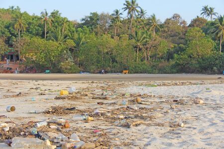 India, Goa, February 05, 2018. Empty plastic and glass bottles lie on the beach and pollute the...