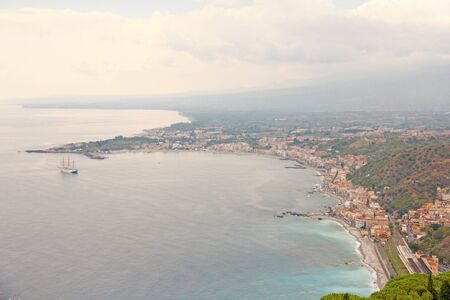 Beautiful Scenic View of the Sea, Green Forest, Taormina's Old Town and Etna Volcano. The island of Sicily, Italy.の写真素材