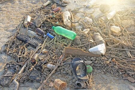 India, Goa, February 05, 2018. Empty plastic and glass bottles lie on the beach and pollute the ecology of the sea.の写真素材