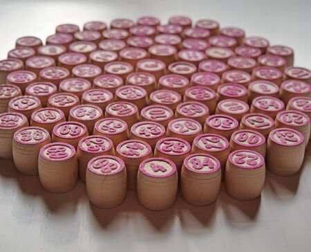 Russian lotto, bingo board game, barrels and cards on a white background. Quarantine Games Concept. Board game lotto with wooden barrels. Money game, luck, luck, excitement, board games, stay home.の写真素材