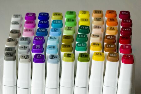 Set of bright multi-colored felt-tip pens or markers with designation of numbers and the name of color. Photo for creativity, drawing for children, design. Felt pens of all colors of the rainbow.の写真素材
