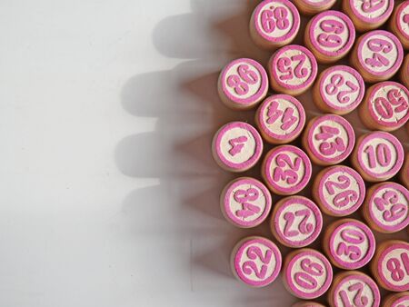 Russian lotto, bingo board game, barrels and cards on a white background. Quarantine Games Concept. Board game lotto with wooden barrels. Money game, luck, luck, excitement, board games, stay home.の写真素材