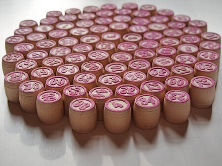 Russian lotto, bingo board game, barrels and cards on a white background. Quarantine Games Concept. Board game lotto with wooden barrels. Money game, luck, luck, excitement, board games, stay home.の写真素材