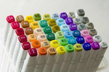 Set of bright multi-colored felt-tip pens or markers with designation of numbers and the name of color. Photo for creativity, drawing for children, design. Felt pens of all colors of the rainbow.の写真素材