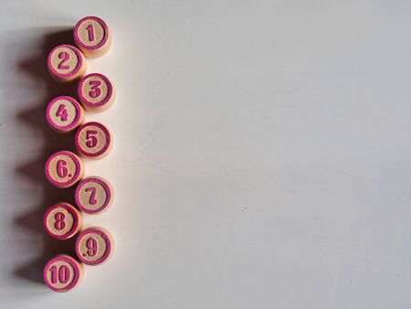 Russian lotto, bingo board game, barrels and cards on a white background. Quarantine Games Concept. Board game lotto with wooden barrels. Money game, luck, luck, excitement, board games, stay home.の写真素材