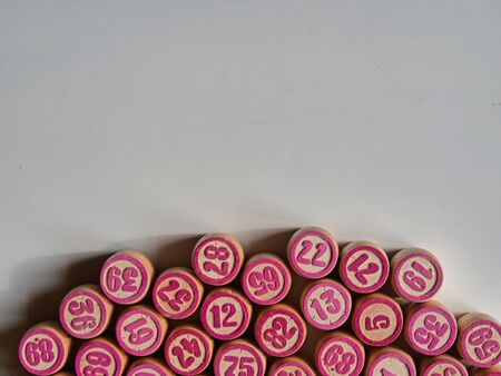 Russian lotto, bingo board game, barrels and cards on a white background. Quarantine Games Concept. Board game lotto with wooden barrels. Money game, luck, luck, excitement, board games, stay home.の写真素材