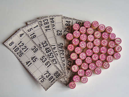 Russian lotto, bingo board game, barrels and cards on a white background. Quarantine Games Concept. Board game lotto with wooden barrels. Money game, luck, luck, excitement, board games, stay home.の写真素材