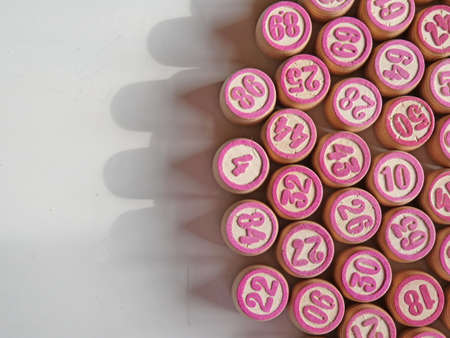 Russian lotto, bingo board game, barrels and cards on a white background. Quarantine Games Concept. Board game lotto with wooden barrels. Money game, luck, luck, excitement, board games, stay home.の写真素材