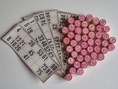 Russian lotto, bingo board game, barrels and cards on a white background. Quarantine Games Concept. Board game lotto with wooden barrels. Money game, luck, luck, excitement, board games, stay home.の写真素材