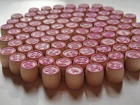 Russian lotto, bingo board game, barrels and cards on a white background. Quarantine Games Concept. Board game lotto with wooden barrels. Money game, luck, luck, excitement, board games, stay home.の写真素材