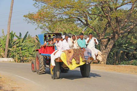 India, Hampi, January 31, 2018. Indian men ride in the back of an open truck.のeditorial素材