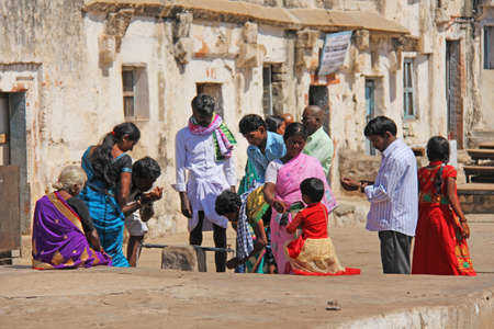 India, Hampi, 01 February 2018. A group of Indian people, men and women, inside the temple of...