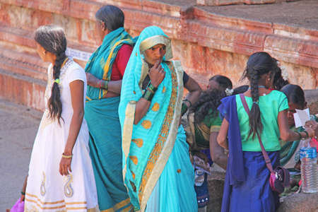India, Hampi, 01 February 2018. A group of Indian women smiling on a street in the village of Hampi, inside the temple of Virupaksha.のeditorial素材