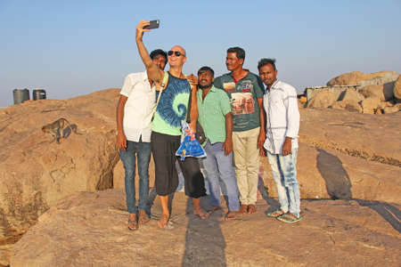 India, Hampi, January 31, 2018. Men Hindus are photographed with a European on the phone. Selfie on the phone.のeditorial素材