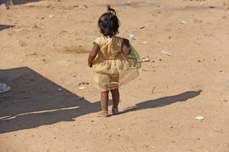 India, Hampi, 02 February 2018. A little poor girl in a dirty dress.のeditorial素材