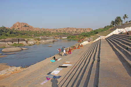 India, Hampi, 02 February 2018. Bath day on the river in the village of Hampi - Tungabhadra. The men are washing on the river in Hampi.のeditorial素材