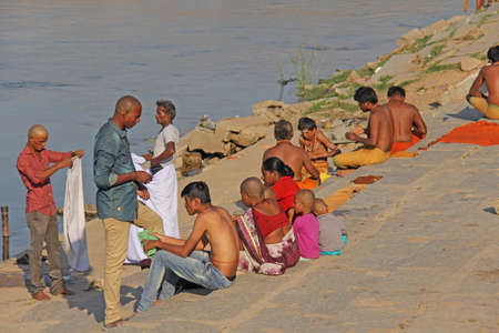 India, Hampi, 02 February 2018. Bath day on the river in the village of Hampi - Tungabhadra. The men are washing on the river in Hampi.のeditorial素材