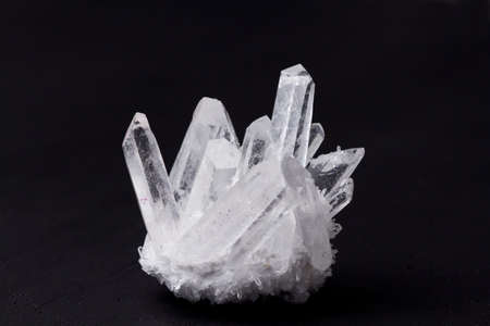 Large crystals of natural transparent stone rock crystal close-up, transparent quartz in crystals, rock, geology, magical rites and esotericism. White transparent stone on a black background.の写真素材