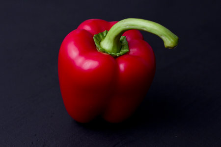 Bright multi-colored bell peppers lie on a isolated white background. Red peppers, orange, yellow...