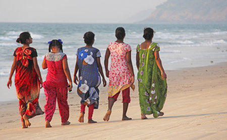 India, GOA, January 22, 2018. A group of Indian women in bright and colorful saris goes along the seashore or the beach. Indian women in sari.のeditorial素材