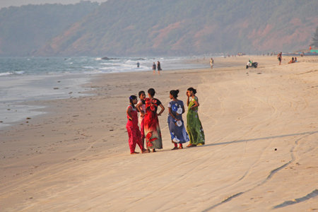 India, GOA, January 22, 2018. A group of Indian women in bright and colorful saris goes along the seashore or the beach. Indian women in sari.のeditorial素材