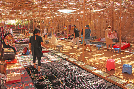 India, GOA, January 24, 2018. Indian market in the village of Anjuna. Bright goods and paints of India. Sellers sell their products on the market.のeditorial素材