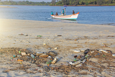India, Goa, February 05, 2018. Empty plastic and glass bottles lie on the beach and pollute the...