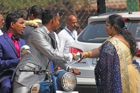 India, GOA, January 28, 2018. The streets of India. People go or ride a scooter down the street. Bright colors of India. Holiday in India.のeditorial素材