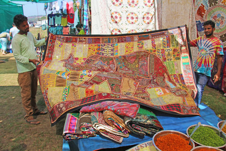 India, Goa. January 24, 2018. A man sells a veil and his goods.のeditorial素材