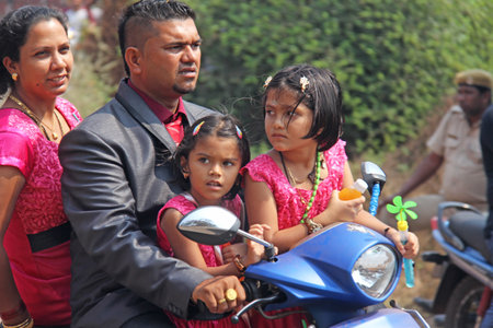 India, GOA, January 28, 2018. The streets of India. People go or ride a scooter down the street. Bright colors of India. Holiday in India.のeditorial素材