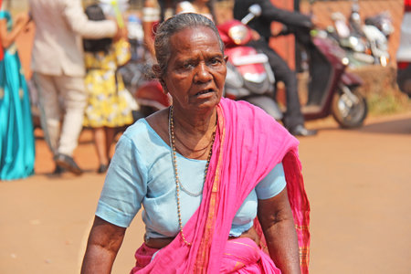 India, GOA, January 28, 2018. Indian elderly woman or grandmother in pink and blue saris, in India.