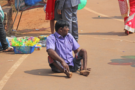 India, GOA, January 28, 2018. A disabled man is sitting on the street in India and asks for money.のeditorial素材