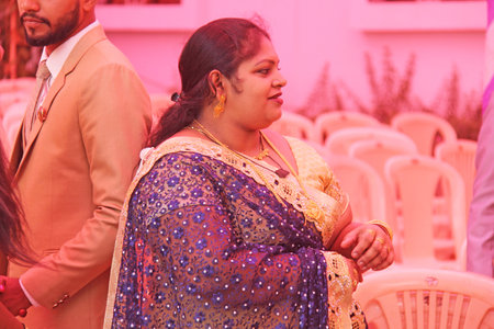 India, GOA, January 28, 2018. The streets of India. People go or ride a scooter down the street. Bright colors of India. Holiday in India.のeditorial素材