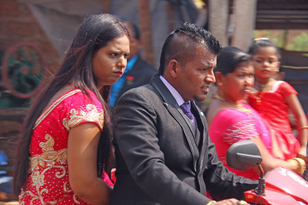 India, GOA, January 28, 2018. The streets of India. People go or ride a scooter down the street. Bright colors of India. Holiday in India.のeditorial素材