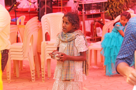 India, GOA, January 28, 2018. Poor child asks money from passers-by, child with outstretched hand, beggar. Poverty in India.のeditorial素材