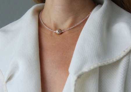 Rose quartz, Kasumi pearl necklace. A short necklace on a girl made of natural Rose quartz, Kasumi pearl stones. Handmade jewelry made from natural stones. Modern jewelry.の写真素材