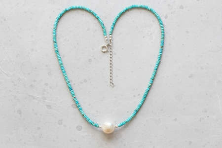 Turquoise, Kasumi pearl necklace. A short necklace made of natural turquoise, Kasumi pearl stones. Handmade jewelry made from natural stones. Modern jewelry. Natural turquoise choker with pearl.の写真素材